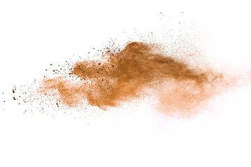 Naklejka na ściany i meble Abstract brown powder explosion. Closeup of brown dust particle splash isolated on white background