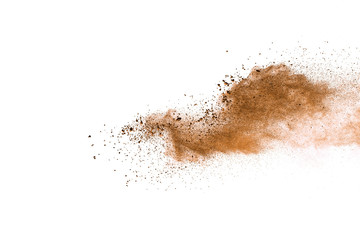 Naklejka na ściany i meble Abstract brown powder explosion. Closeup of brown dust particle splash isolated on white background