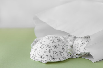 Bra and panties in a gift bag. Copy space. The concept of clothing, shopping, lingerie.