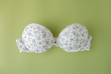 Beautiful bra on a light green background. The concept of clothing, shopping, lingerie.