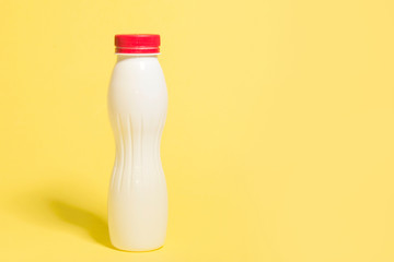 white plastic bottle on a yellow background