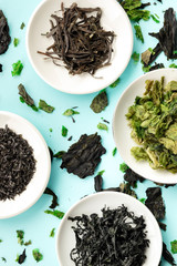 Dry seaweed, sea vegetables, overhead shot on a teal blue background