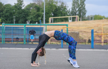 Girl stretches on the playground