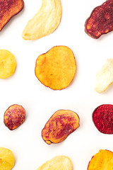 Naklejka premium Dry fruit and vegetable chips, overhead shot. Healthy vegan snack, an organic food flat lay pattern on a white background
