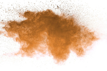 Explosion of brown powder on white background. 