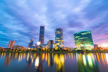 Night cityscape of Yekaterinburg, Russia with city lights reflecting in water