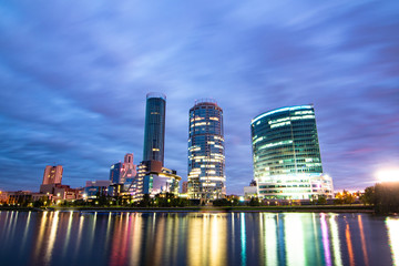 Night cityscape of Yekaterinburg, Russia with city lights reflecting in water