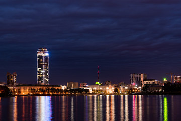 View of Yekaterinburg city pond with night city lights and skyscraper