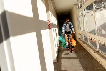 BMX rider in a corridor using smoke grenade