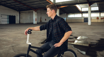 BMX rider in an empty warehouse
