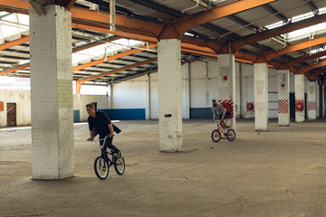 BMX rider in an empty warehouse
