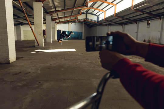 BMX riders in an empty warehouse