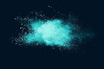 Explosion of aqua color powder on black background. 