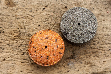 Round briquettes of pressed flax seed and sunflower seed. It is used as feed for animals, birds and fish. One of the feed ingredients