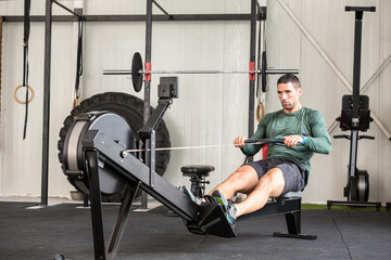 Man using rowing machine in a gym