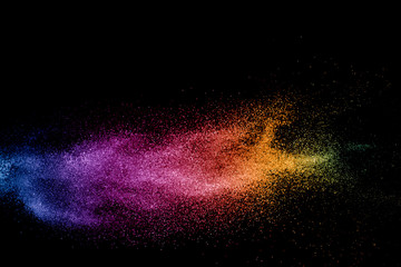 abstract colored dust explosion on a black background.abstract powder splatted background,Freeze motion of color powder exploding/throwing color powder, multicolored glitter texture.