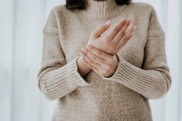 woman holding her wrist pain