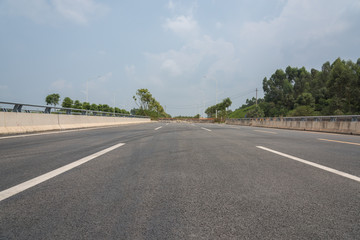 Fototapeta premium Perspective view of the viaduct asphalt pavement in the suburbs of the city