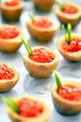 Delicious tartlets with red caviar. Concept of food, restaurant, catering, menu.