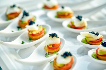 Delicious tartlets with black caviar. Concept of food, restaurant, catering, menu.