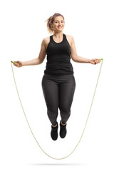 Young cheerful woman skipping a rope - obrazy, fototapety, plakaty