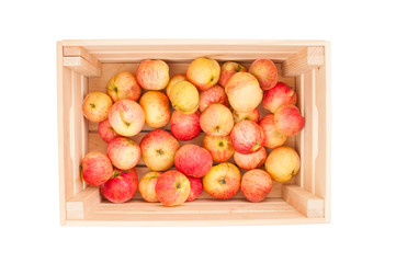 Fresh organic apples in wooden crate isolated on white background