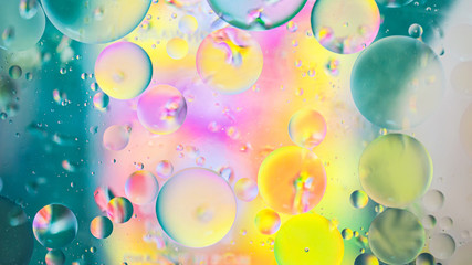 Colorful artistic image of oil drop on water for modern and creation design background.