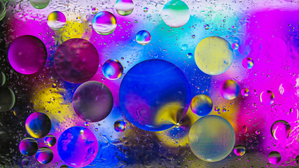 Colorful artistic image of oil drop on water for modern and creation design background.