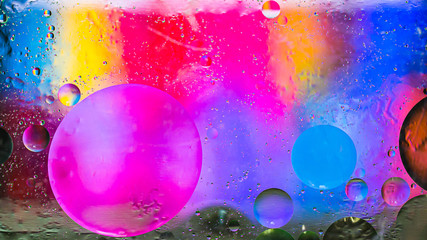 Colorful artistic image of oil drop on water for modern and creation design background.