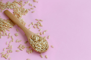 Brown rice in a wooden spoon