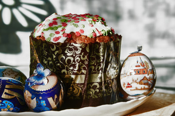 With an Easter cake and colored eggs for Easter