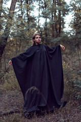 Young blonde girl in a city forest