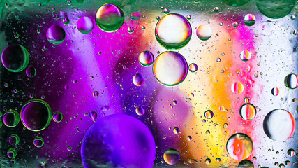 Colorful artistic image of oil drop on water for modern and creation design background.