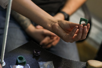 A jewelry master is working to create a silver ring