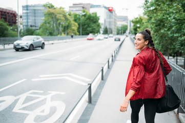 Woman looking back while walking on the way to the gym.