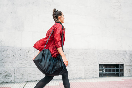 Woman looking forward while walking on the way to the gym.