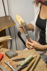 A jewelry master is working to create a silver ring