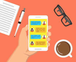 Hand holding smartphone with text messaging on the screen. Сup of coffee, notebook with pen and glasses lay on the table. Vector flat illustration.