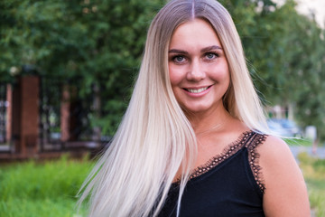 Naklejka premium Portrait of a beautiful young woman with long shiny blond hair looking at the camera. Hair care concept.