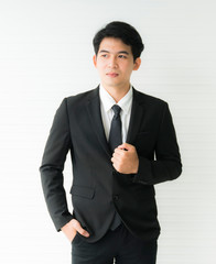 Portrait business man standing. wearing a black suit Isolated on white background