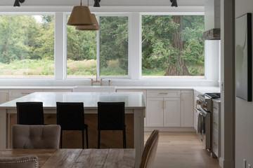 Brightly lit open concept kitchen at a modern farmhouse or beach condo