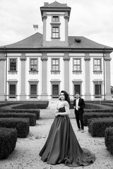 Naklejka premium Couple in love. Attractive happy girl and the guy. Sexy elegant couple in the tender passion. Beautiful woman near the man. Love story of the beautiful young man and woman. Honeymoon. Black and white