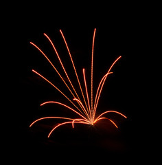 Orange fireworks expolde in the sky