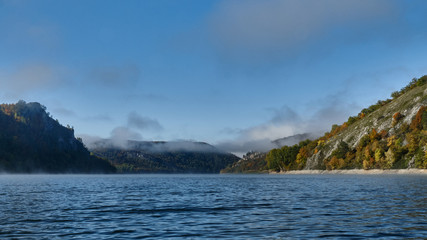 Foggy landscape in autumn on a lake in Norway in the mountains.