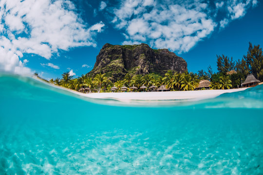 Tropical crystal ocean with Le Morne mountain and luxury beach in Mauritius. Split view.