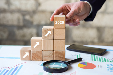 Business concept growth 2020 success process, Businessman hand arranging wood block stacking as...
