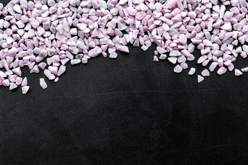 Design with pebble on black background top view space for text