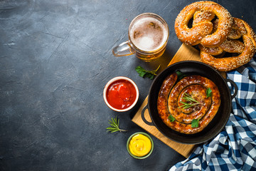 Oktoberfest food - sausage, beer and bretzel.