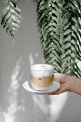 hand holding a cup of coffee