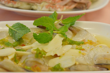 Raw shrimp in fish sauce and spicy sauce with vegetable on plate.